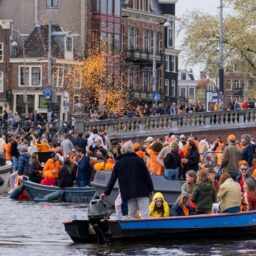 a large group of people in boats on a river
