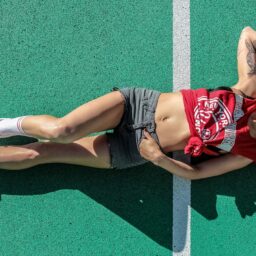 woman lying on sports field